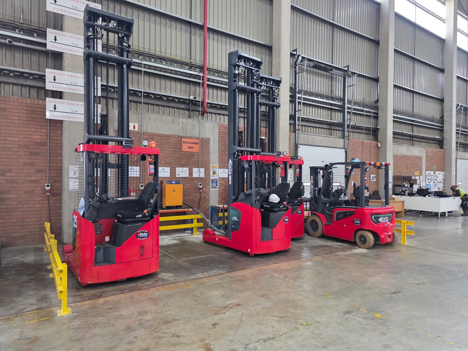 Forklift moving through a warehouse aisle