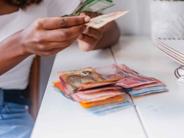 Woman counting south african rands